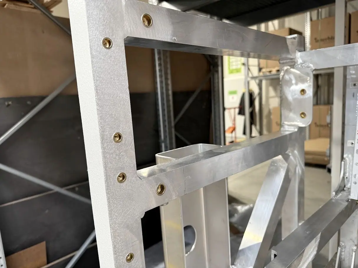 Aluminium frame assembly with riveted brackets